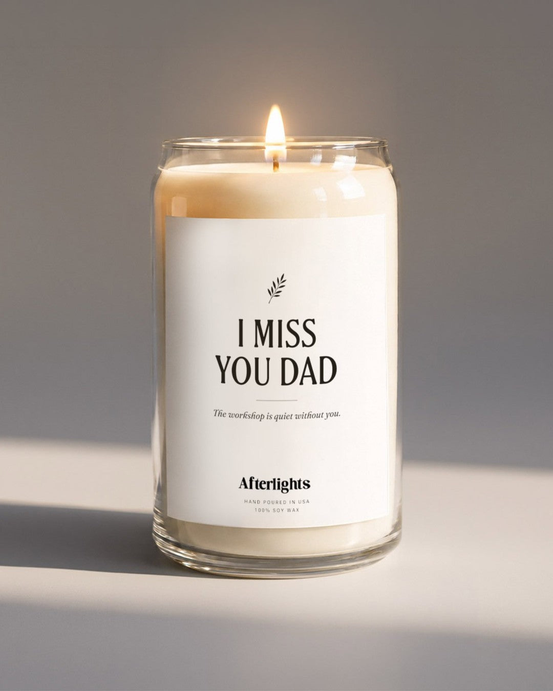 Memorial candle that says I Miss You Dad with an olive branch
