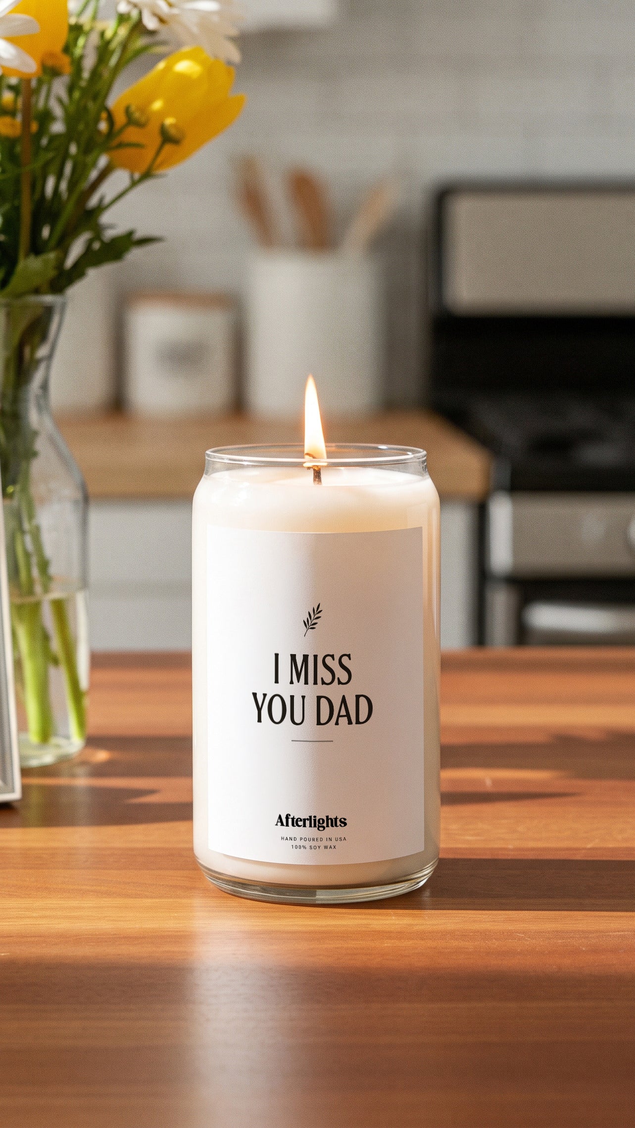 Personalized memorial candle with an olive branch symbol on a kitchen table